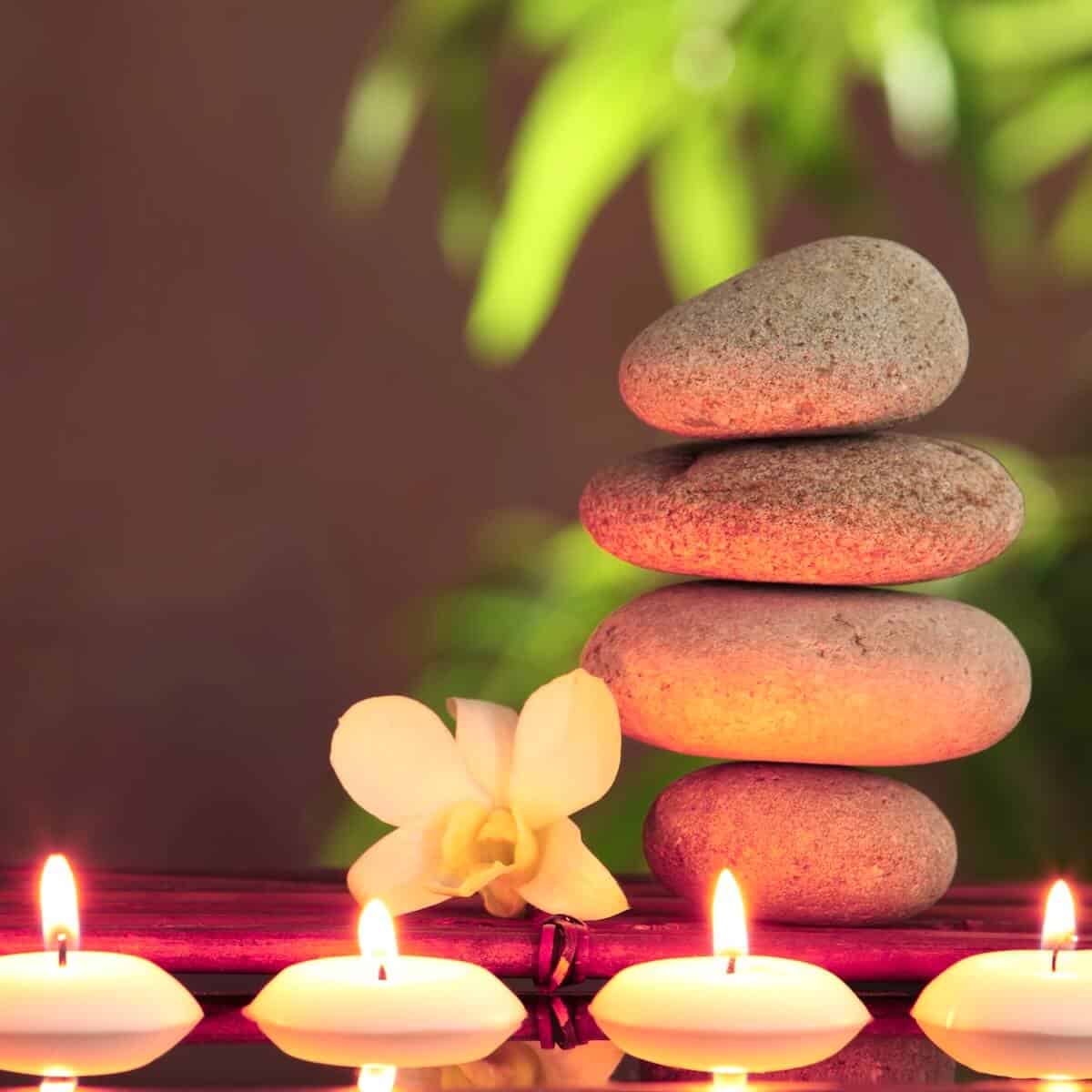 Candles & Stones Stacked stones, orchid flower and candles creating a relaxing spa atmosphere.
