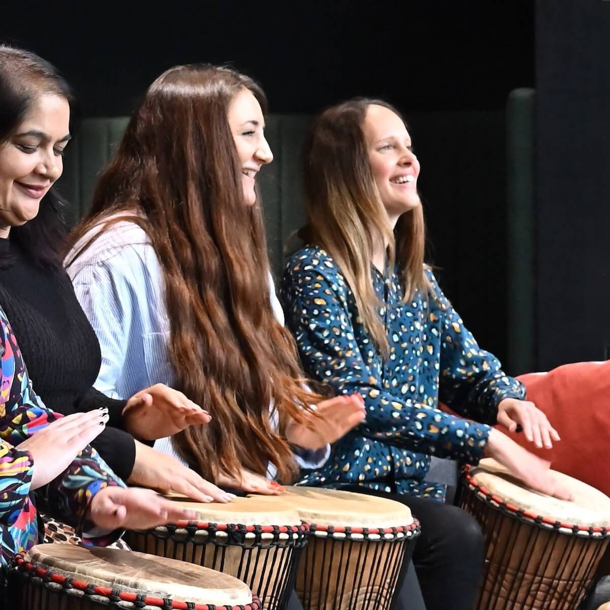 Women Drumming - Primal Sound Session Group of women drumming together on djembes during a community drumming session – Primal Sound