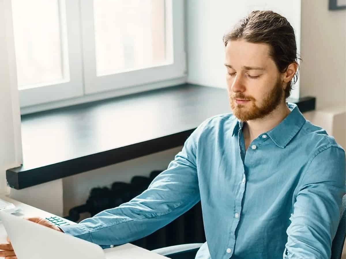 Primal Sound Learn Calm - Office Wellbeing Office worker taking a mindful break with gentle breathwork from a Learn Calm wellbeing session